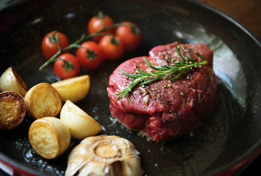 Steak cooking with tomatoes and potatoes
